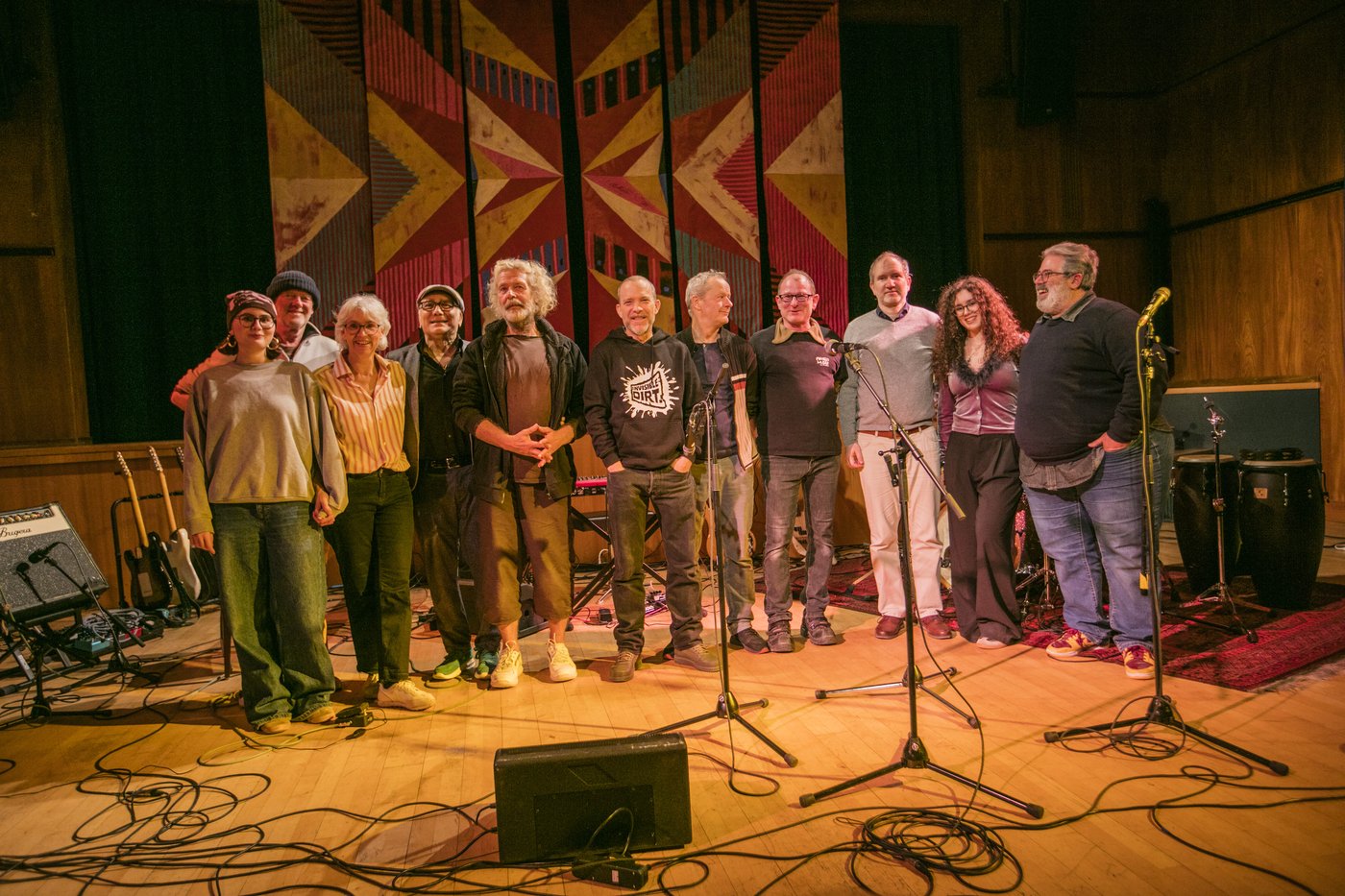 a group of 11 happy looking people on a stage